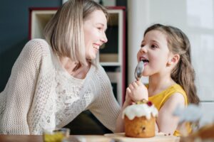 empower-mums Mum and daughter enjoying eating cake together