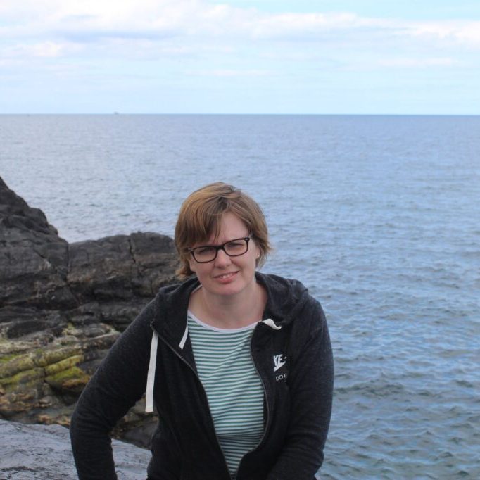 img-0749.JPG Lady sitting on rock with background of sea